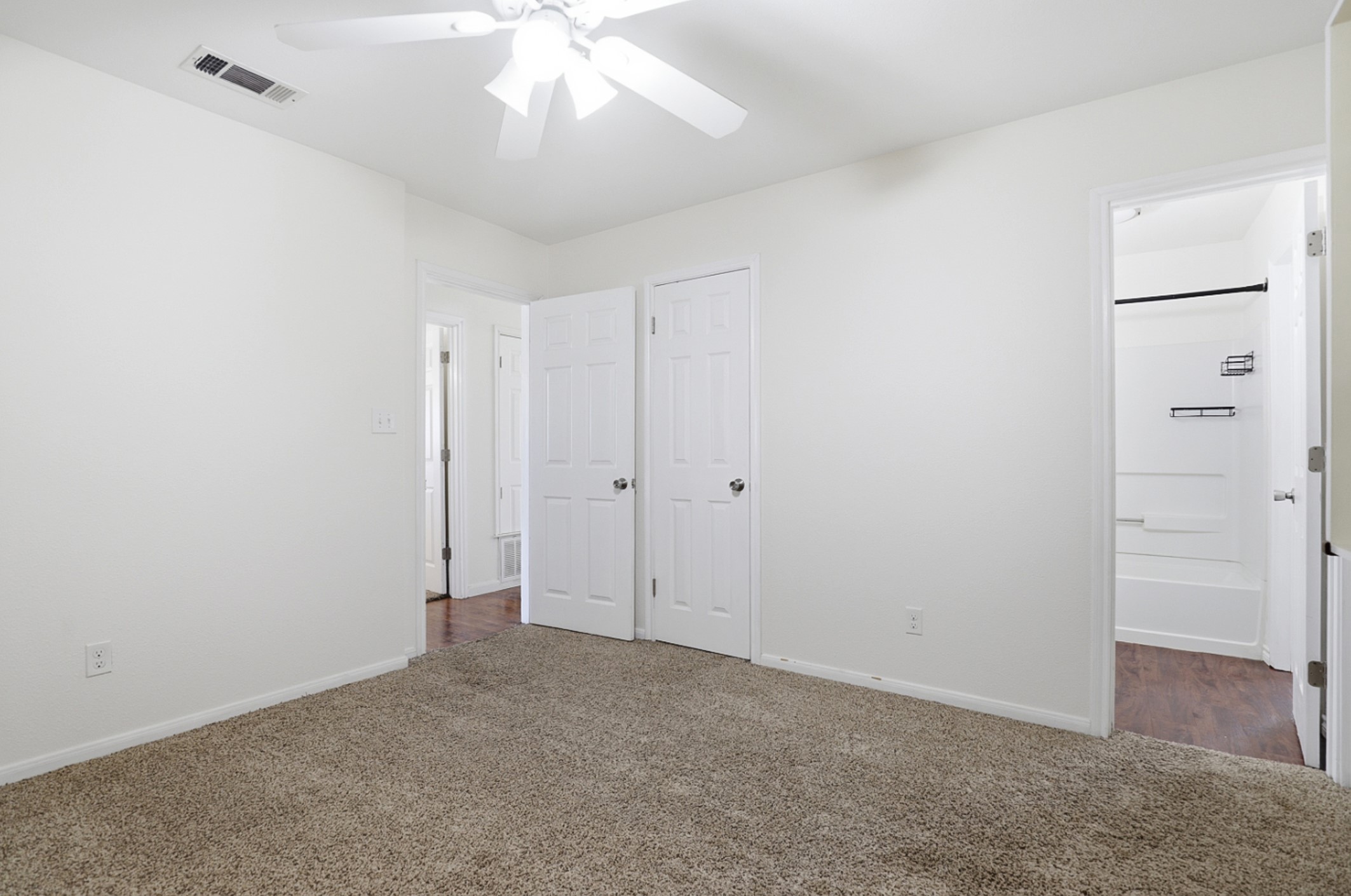 128 Skyview Terrace Leander, TX 78641 - Photo 17 of 23 Unfurnished bedroom with carpet, ensuite bath, and ceiling fan