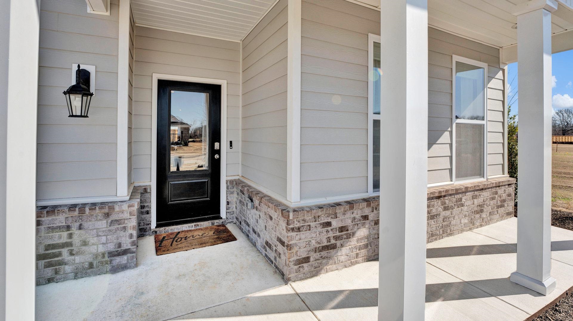 1020 Mewborn Farm Road Oakland, TN 38060 - Photo 3 of 36 View of exterior entry featuring covered porch and brick siding