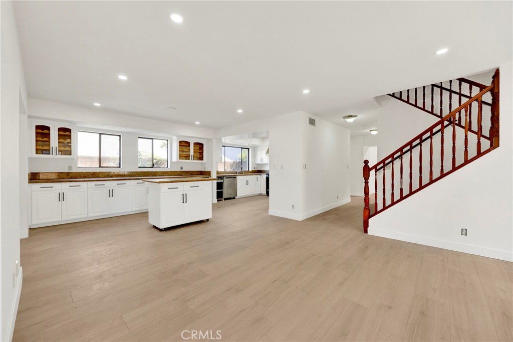 20243 Lanark Street Winnetka, CA 91306 - Photo 12 of 38 a large white kitchen with a sink and dishwasher a refrigerator with wooden floor
