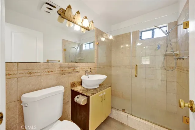 a bathroom with a toilet sink and shower