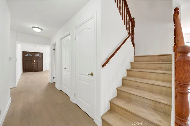 a view of staircase with white walls and railing
