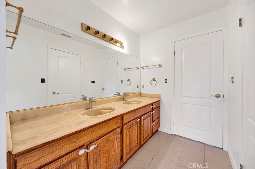 20243 Lanark Street Winnetka, CA 91306 - Photo 26 of 38 a bathroom with a granite countertop sink and a mirror
