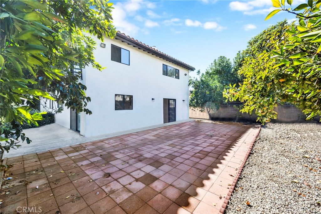 20243 Lanark Street Winnetka, CA 91306 - Photo 35 of 38 a front view of a house with a yard and a garage
