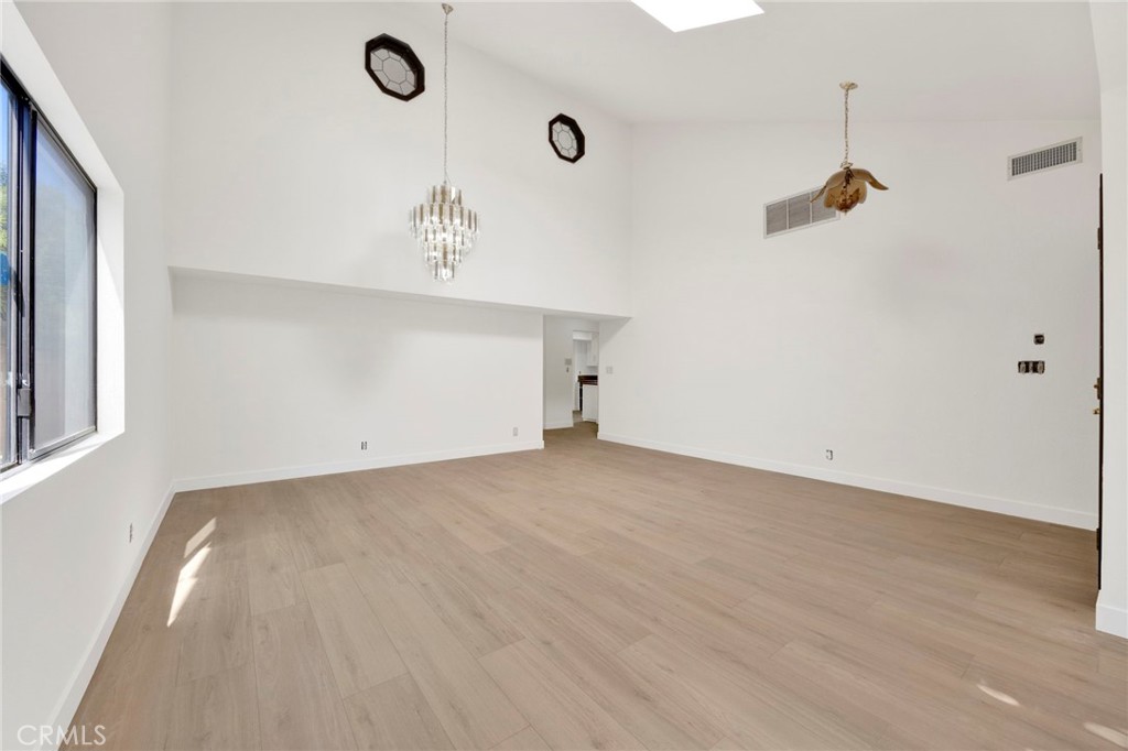 20243 Lanark Street Winnetka, CA 91306 - Photo 5 of 38 an empty room with wooden floor and windows