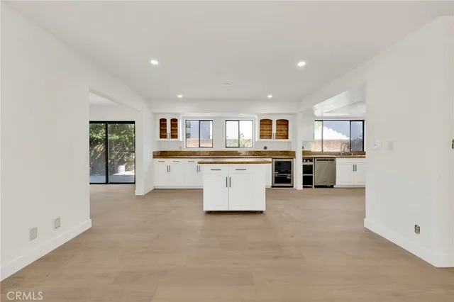 a large kitchen with cabinets and stainless steel appliances