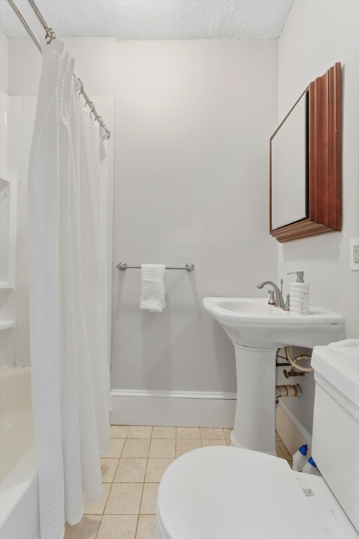 592 Columbus Avenue, Unit PH1 Boston, MA 02118 - Photo 6 of 9 a bathroom with a sink a toilet and a mirror