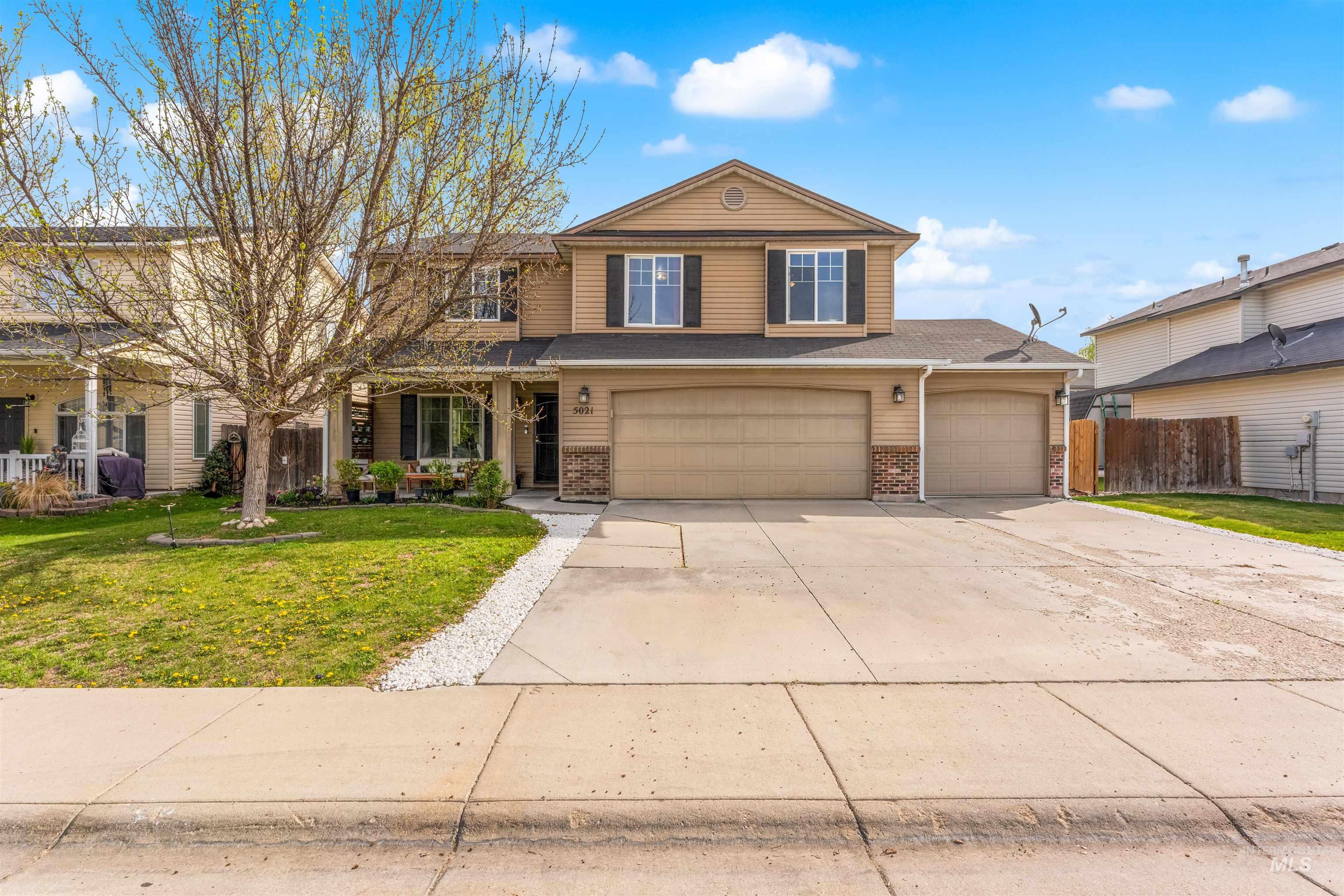 5021 Lathrop Place Caldwell, ID 83607 - Photo 1 of 43 Traditional-style house with concrete driveway, brick siding, an attached garage, and roof with shingles