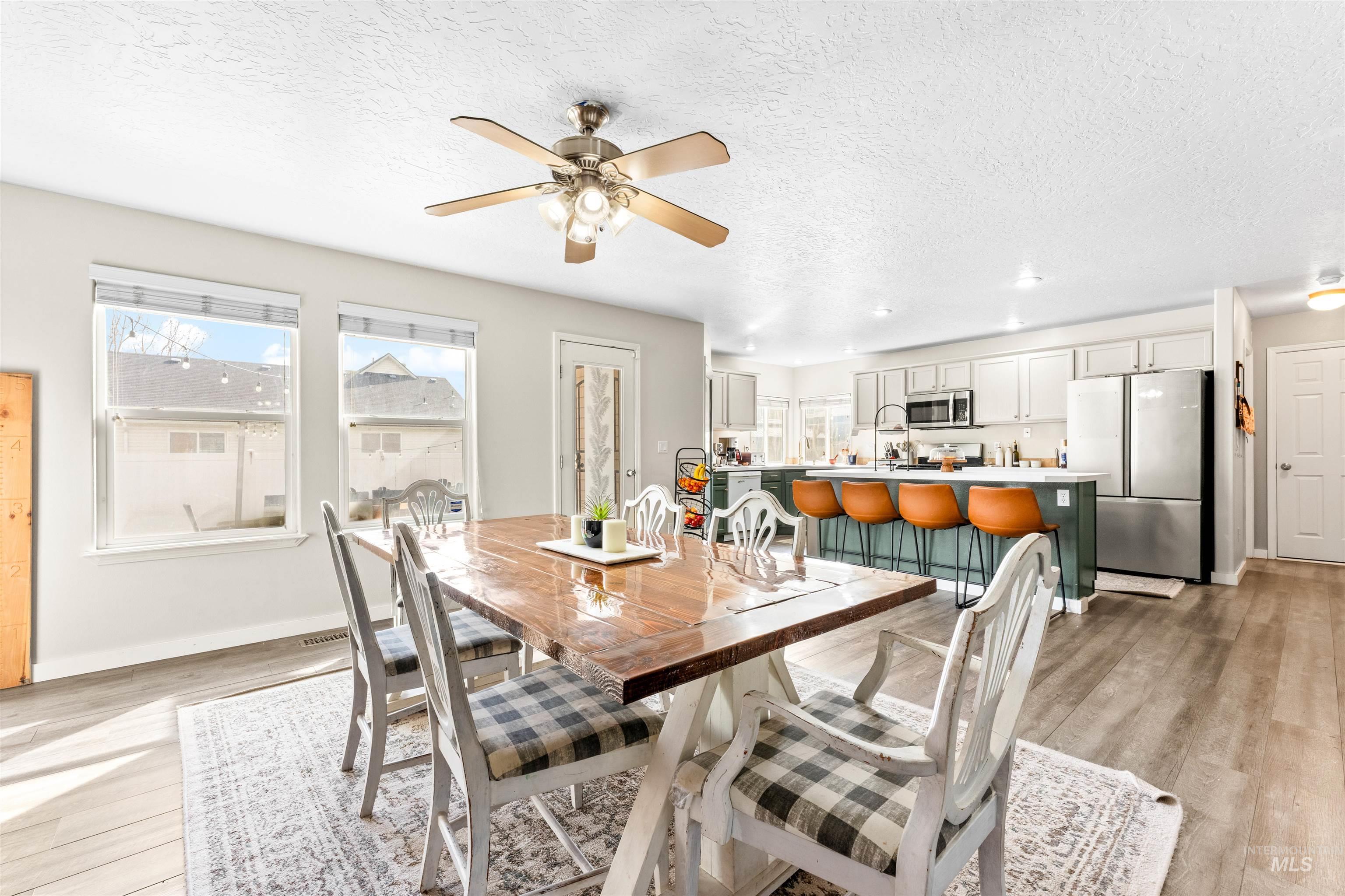 5021 Lathrop Place Caldwell, ID 83607 - Photo 13 of 43 Dining room with light wood-style flooring, a ceiling fan, recessed lighting, and a textured ceiling