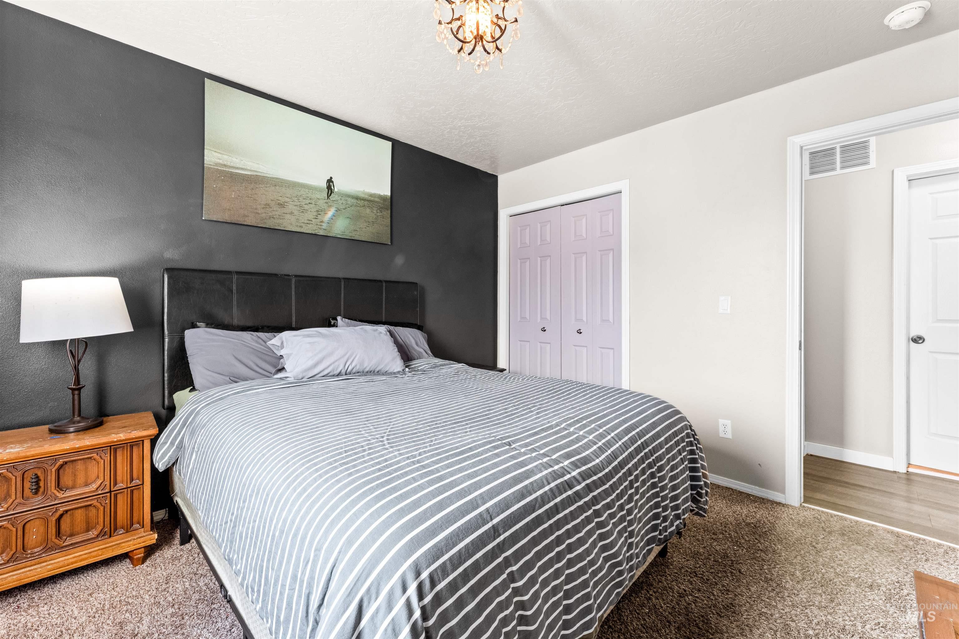 5021 Lathrop Place Caldwell, ID 83607 - Photo 20 of 43 Bedroom featuring light carpet, a closet, and a textured ceiling