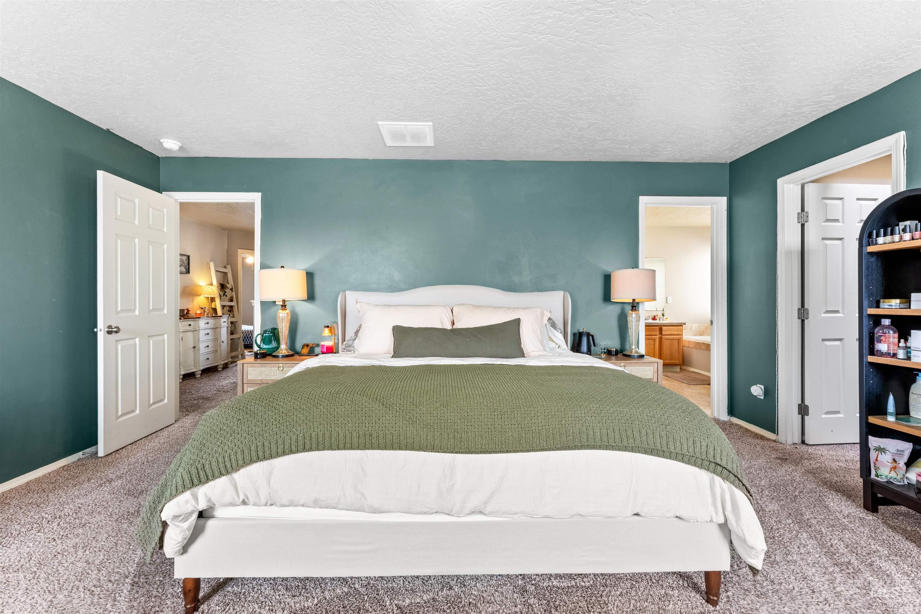 5021 Lathrop Place Caldwell, ID 83607 - Photo 23 of 43 Bedroom with carpet flooring, ensuite bathroom, and a textured ceiling