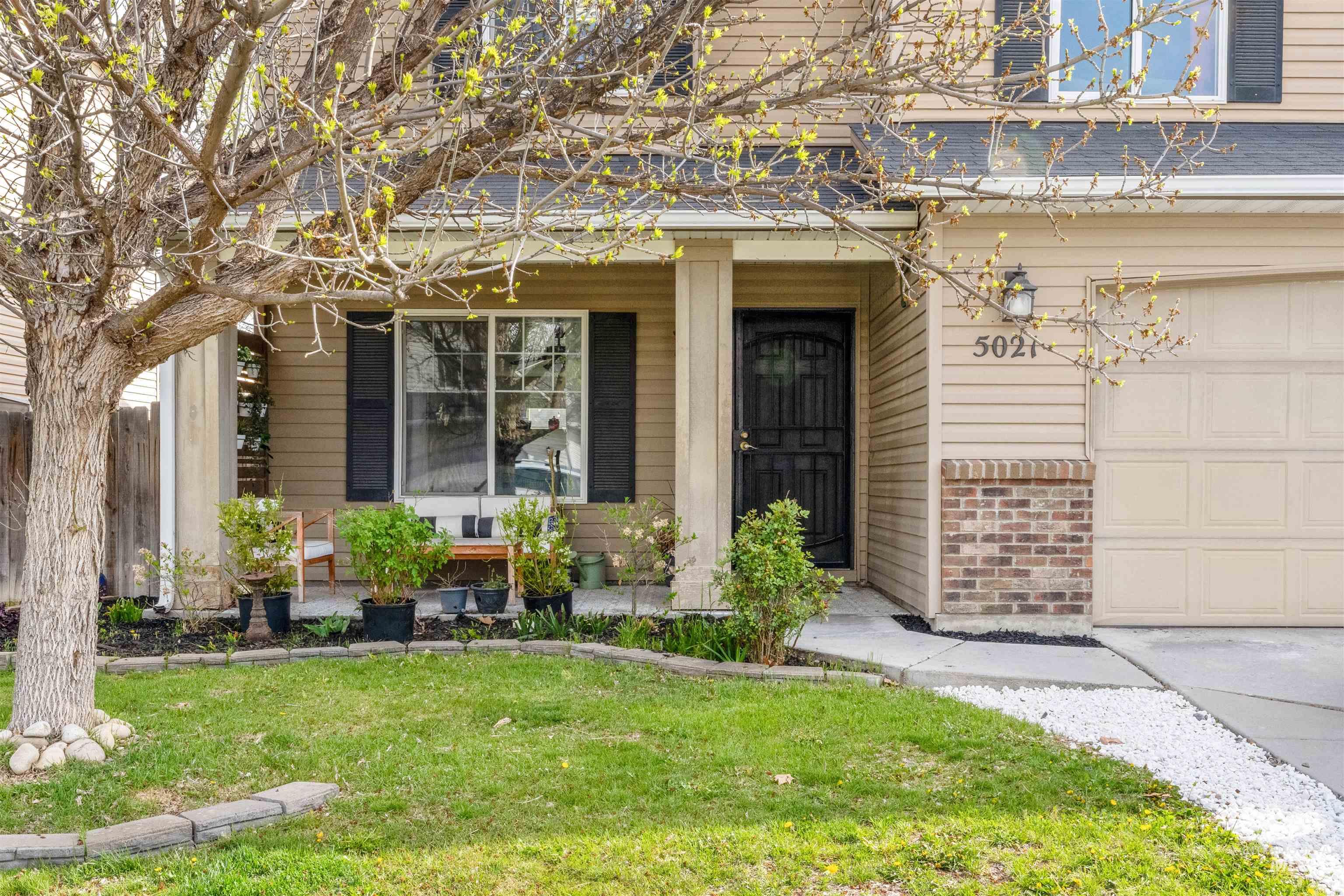 5021 Lathrop Place Caldwell, ID 83607 - Photo 3 of 43 Doorway to property featuring a lawn, roof with shingles, and brick siding