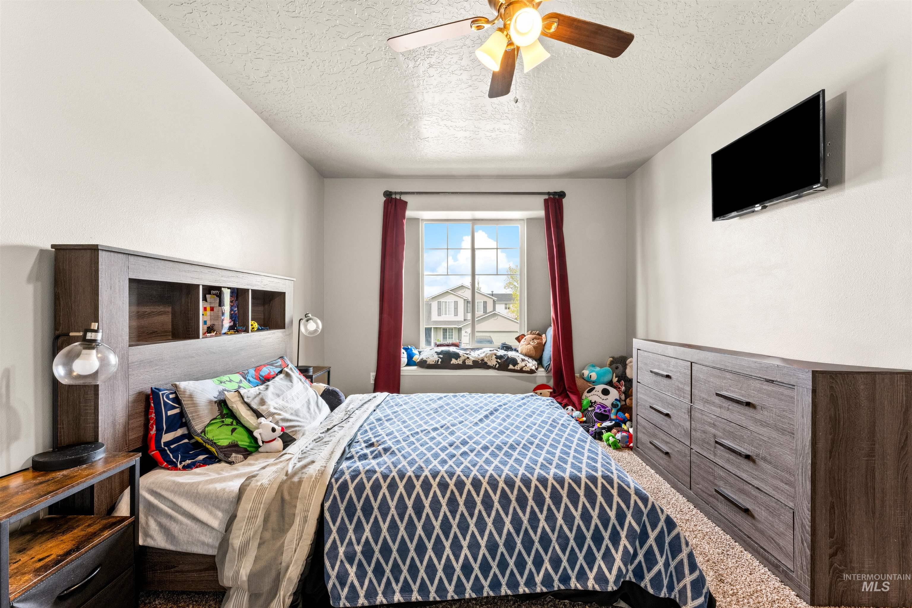 5021 Lathrop Place Caldwell, ID 83607 - Photo 30 of 43 Carpeted bedroom with a textured ceiling and ceiling fan