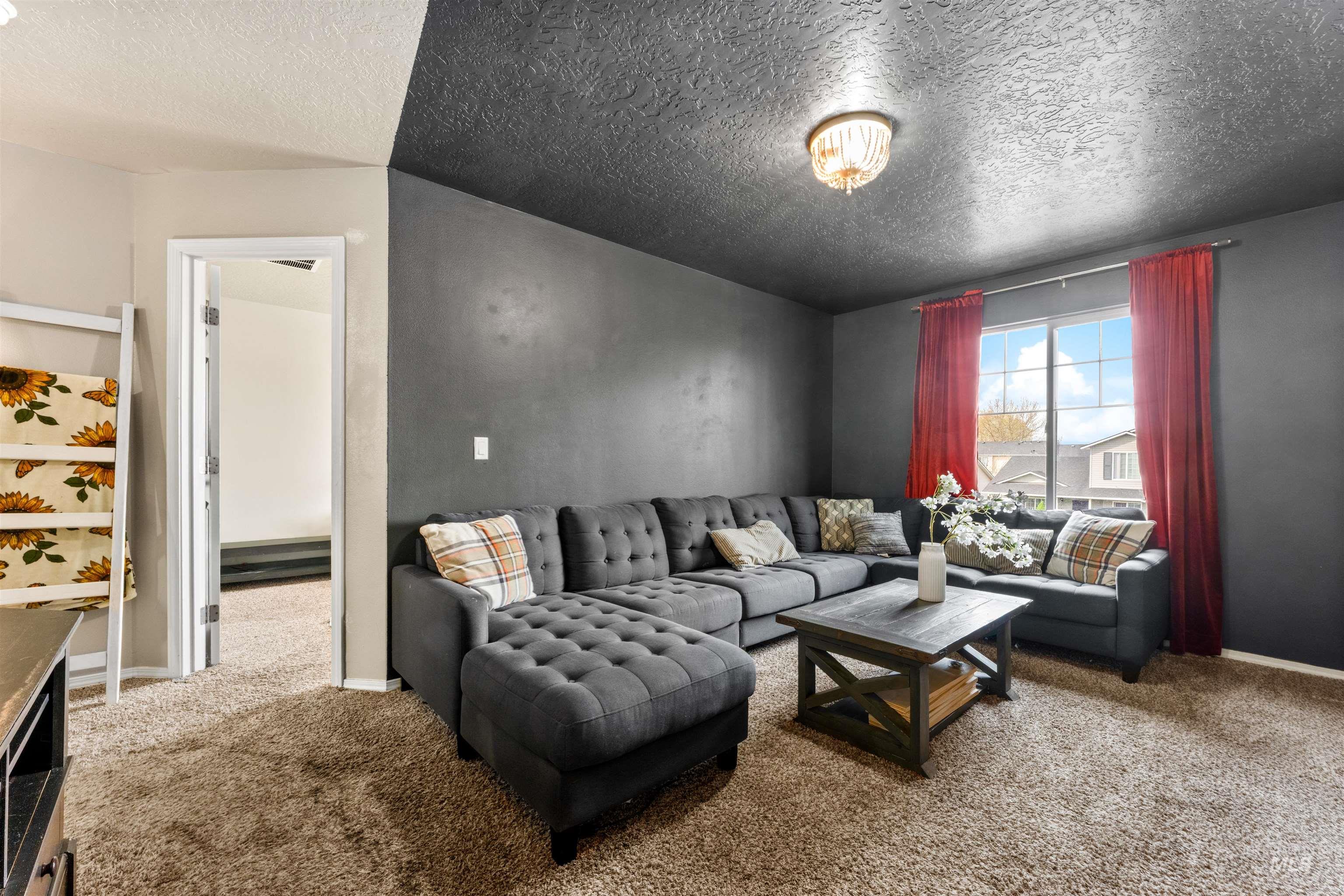 5021 Lathrop Place Caldwell, ID 83607 - Photo 32 of 43 Living room featuring carpet flooring and a textured ceiling
