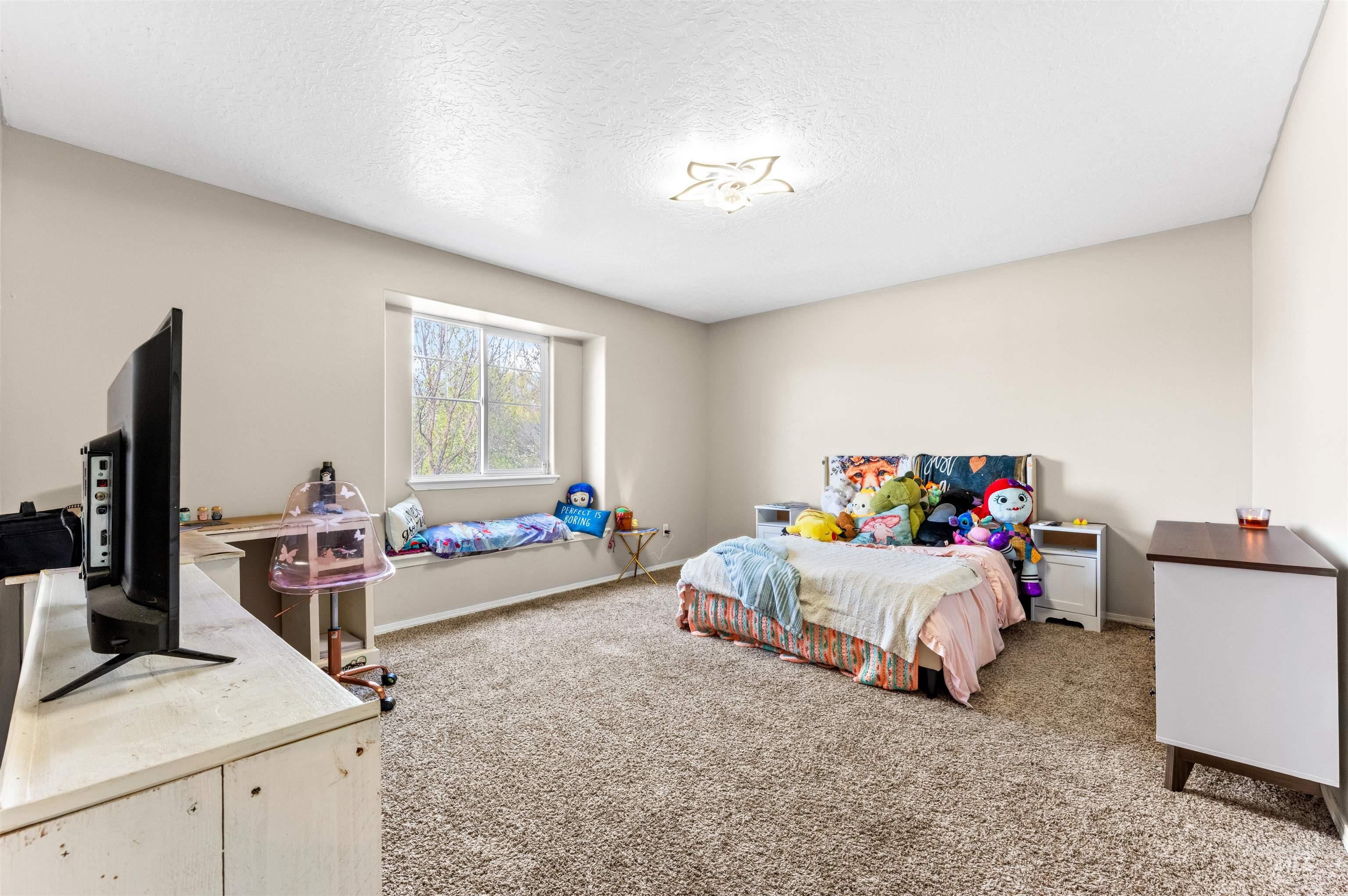 5021 Lathrop Place Caldwell, ID 83607 - Photo 34 of 43 Bedroom featuring carpet and a textured ceiling