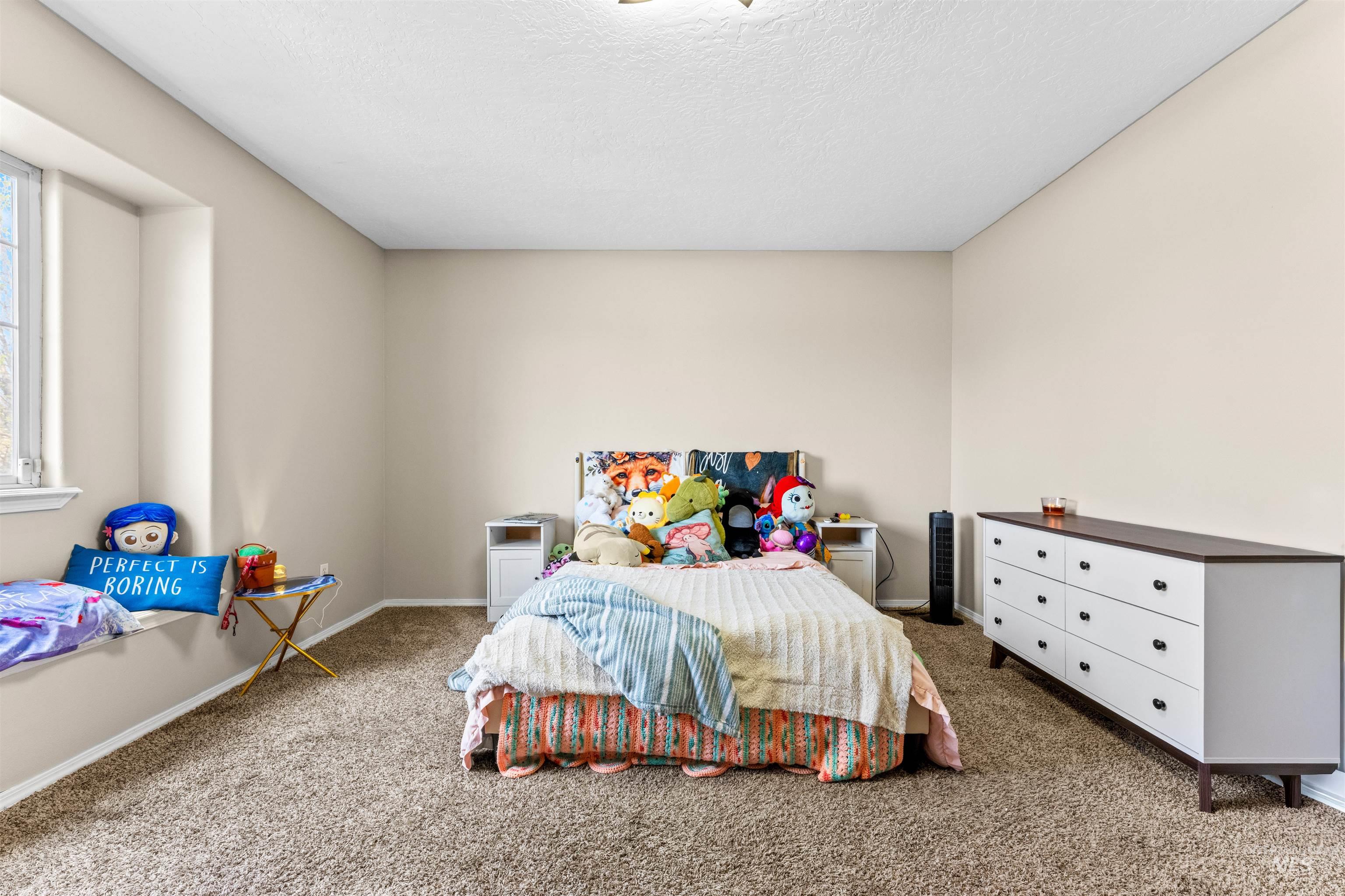 5021 Lathrop Place Caldwell, ID 83607 - Photo 35 of 43 Bedroom with dark colored carpet and a textured ceiling