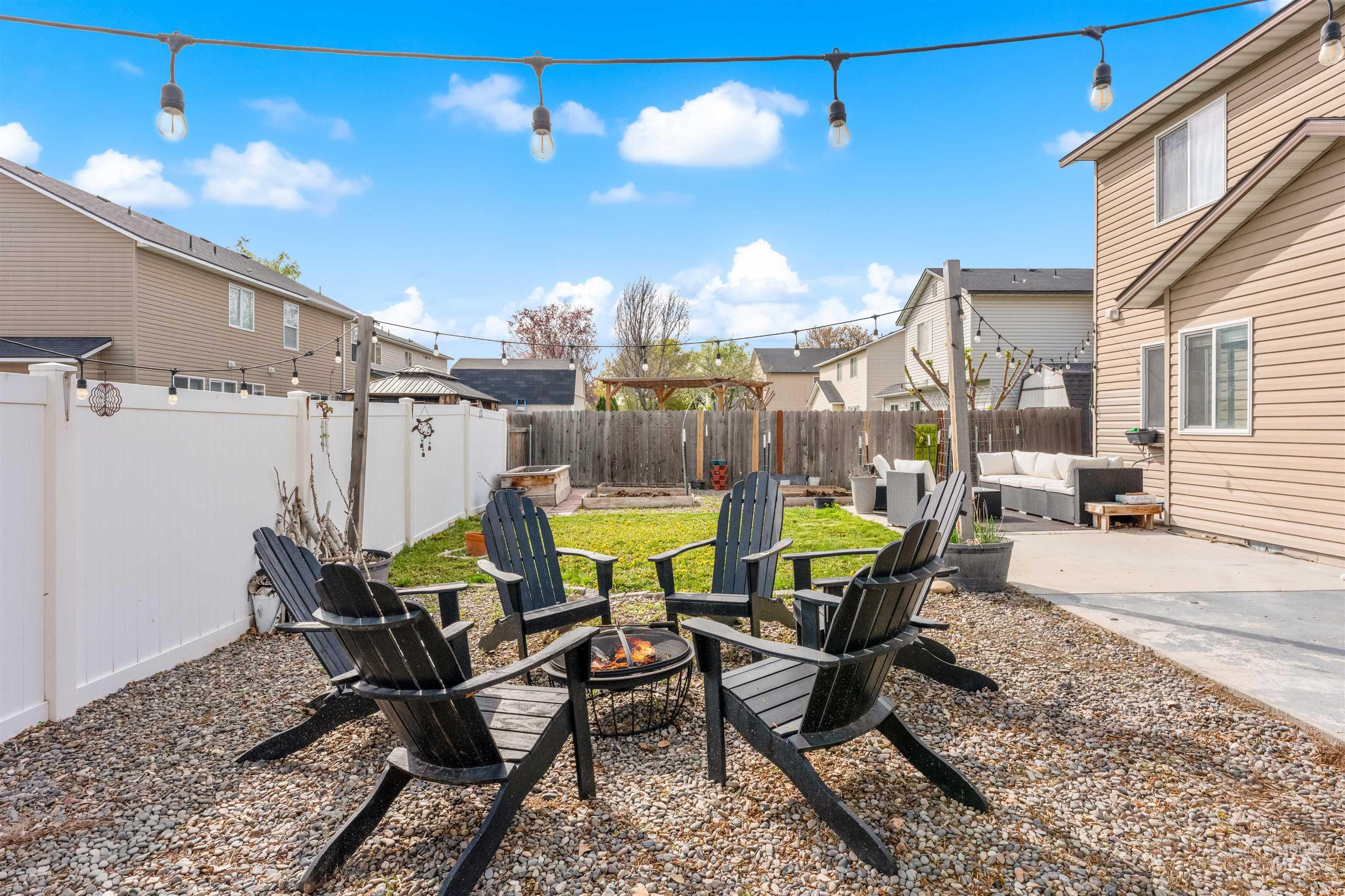 5021 Lathrop Place Caldwell, ID 83607 - Photo 39 of 43 Fenced backyard with a patio and an outdoor living space with a fire pit