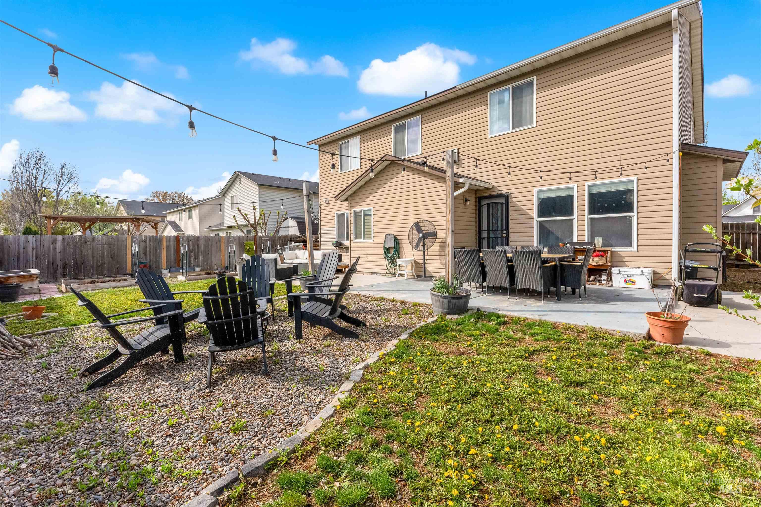 5021 Lathrop Place Caldwell, ID 83607 - Photo 40 of 43 Rear view of house with a patio area, a fenced backyard, and an outdoor fire pit