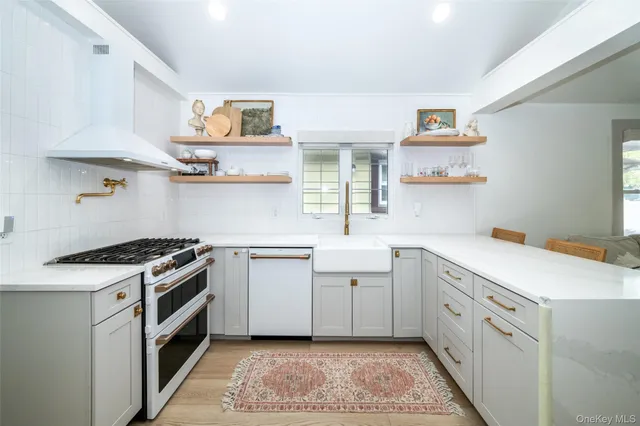 a kitchen with white cabinets and white appliances