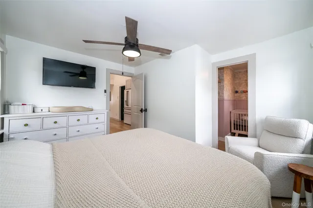 a bedroom with a large bed and a flat screen tv