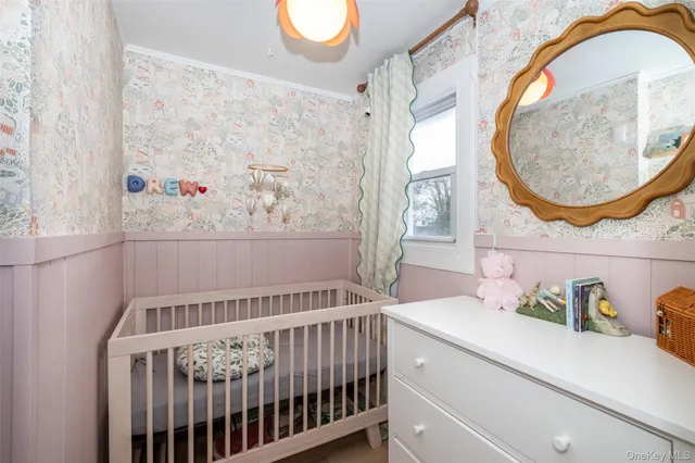 a bedroom with a bed and a mirror