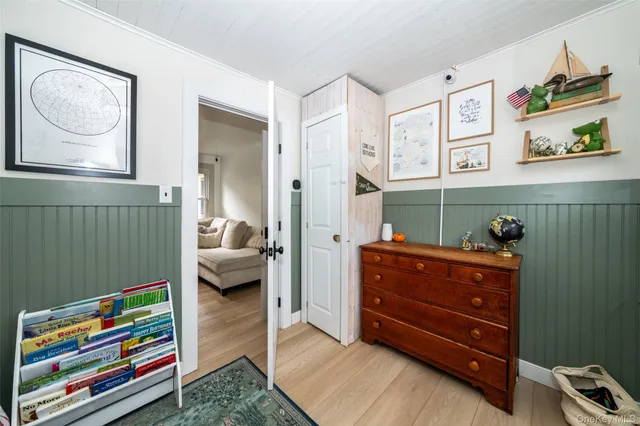 a bedroom with a baby crib and a dresser