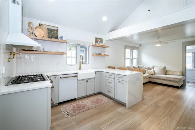 a kitchen with a sink stove and cabinets