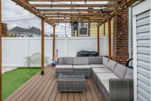 a view of a patio with couches chairs and wooden floor