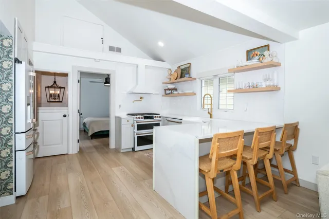 a kitchen with stainless steel appliances a stove a refrigerator and cabinets