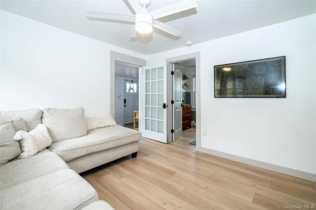 a spacious bedroom with a bed and a flat screen tv