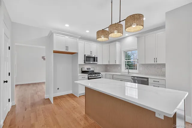 a kitchen with a stove a sink and a refrigerator