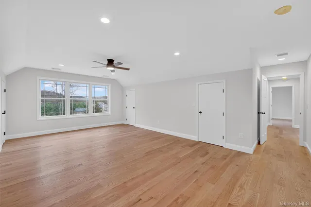 a bathroom with double vanity sinks a toilet a mirror and a window