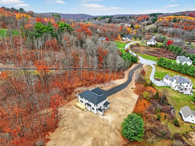 an aerial view of a house with a garden and swimming pool