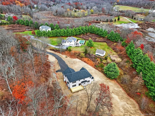 a view of a house with a yard and potted plants