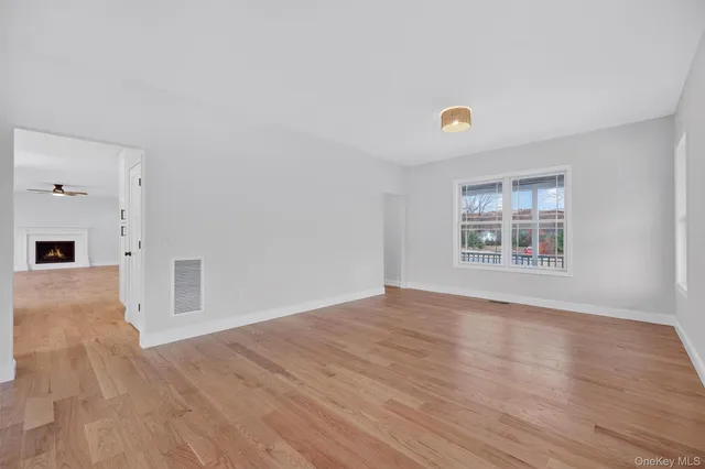 a living room with furniture a rug potted plant and a large window
