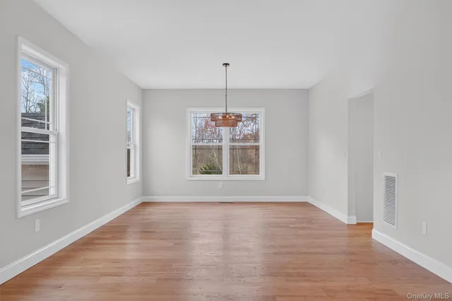 a living room with furniture a rug and wall paintings