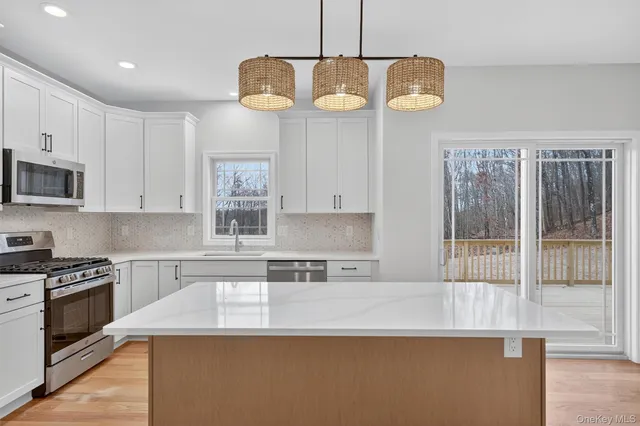 a kitchen with stainless steel appliances granite countertop counter space a sink and cabinets