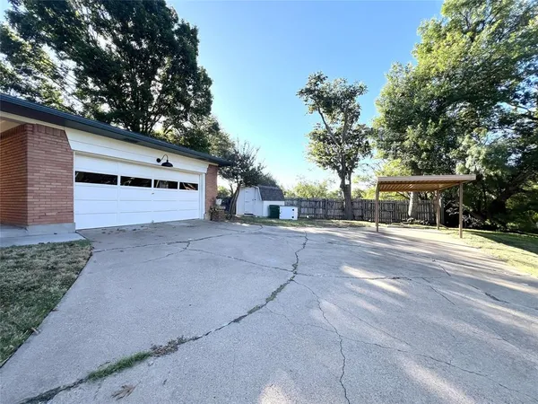 a view of a house with a yard and garage