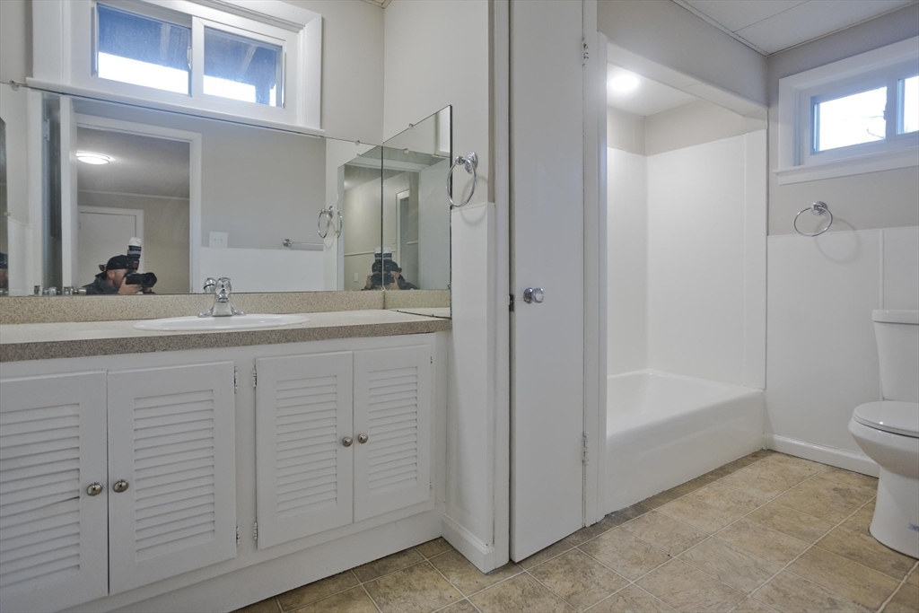 177 Marion Street Chicopee, MA 01013 - Photo 18 of 36 a spacious bathroom with a shower sink and mirror