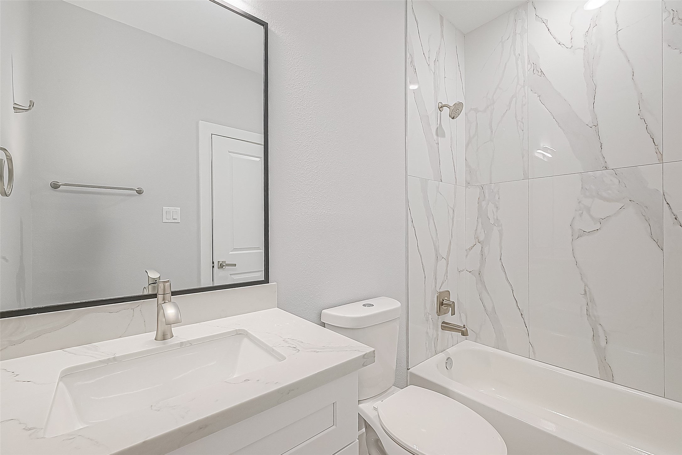 9204 Buffum Street Houston, TX 77051 - Photo 11 of 19 a white toilet sitting next to a bathroom sink and vanity