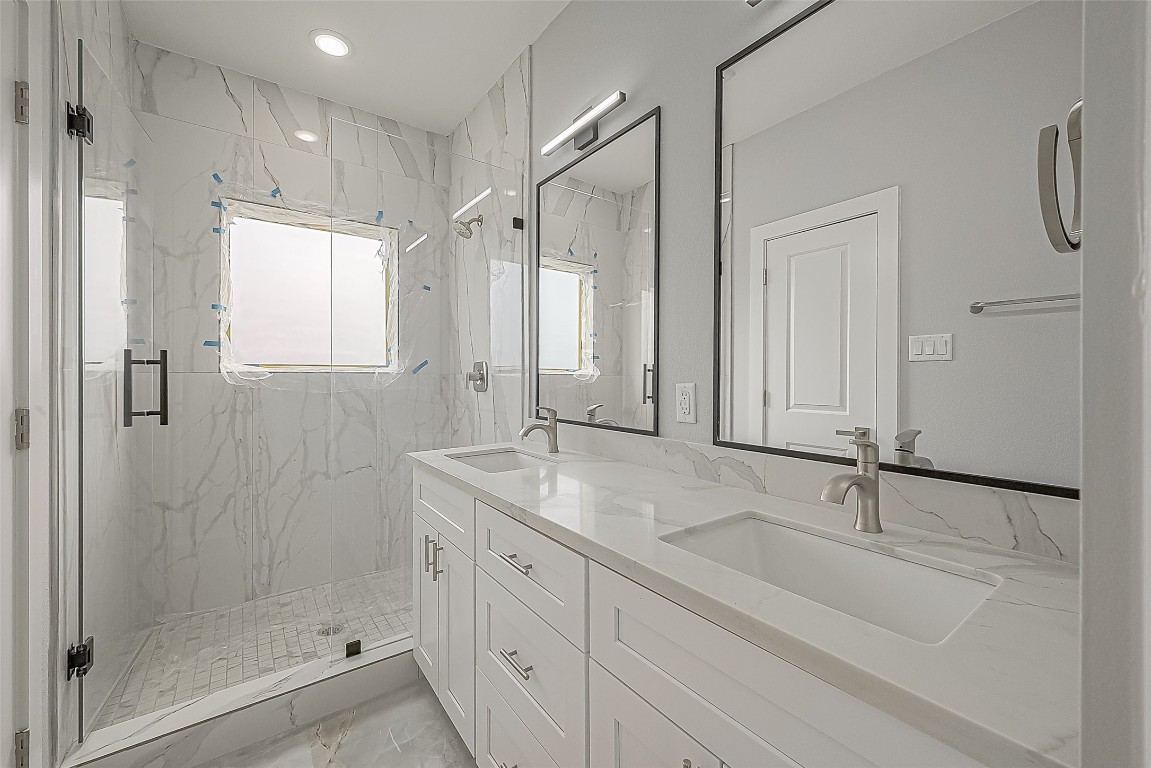 9204 Buffum Street Houston, TX 77051 - Photo 15 of 19 a bathroom with a shower sink and mirror
