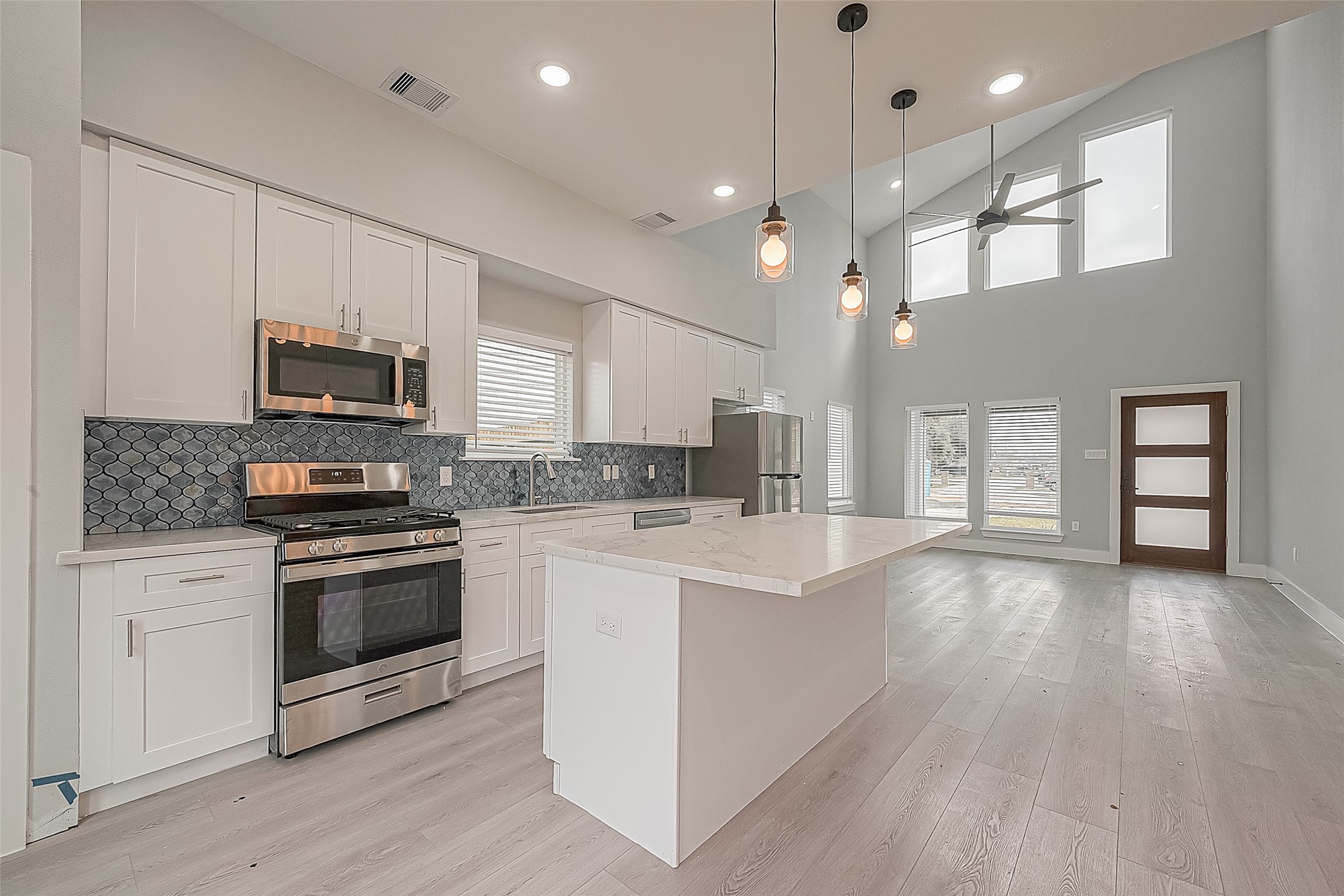 9204 Buffum Street Houston, TX 77051 - Photo 4 of 19 a kitchen with a stove a sink and a microwave