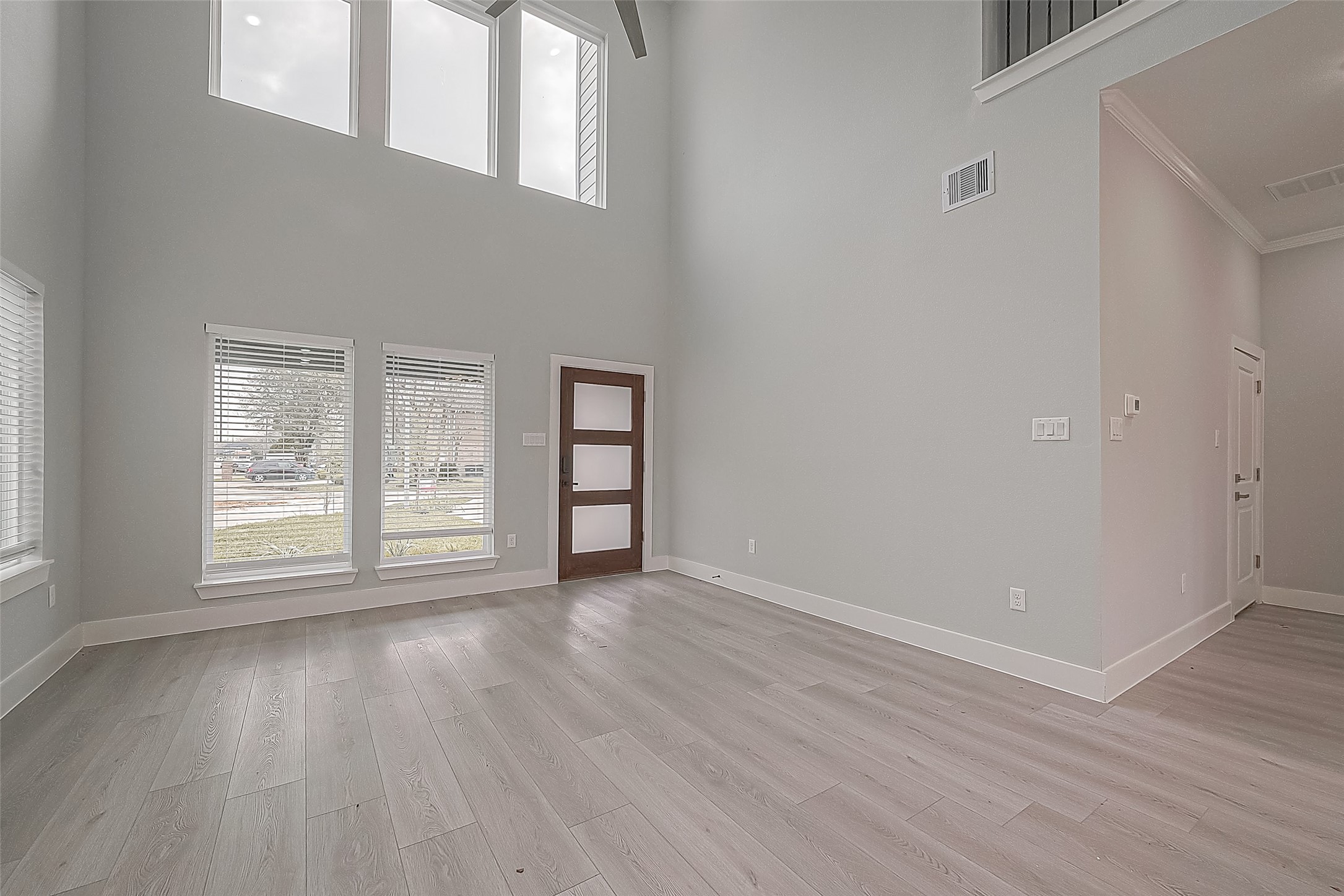 9204 Buffum Street Houston, TX 77051 - Photo 7 of 19 an empty room with wooden floor and windows