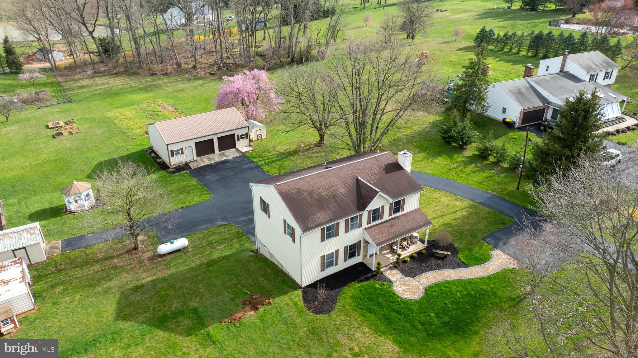an aerial view of a house with yard basket ball court and outdoor seating