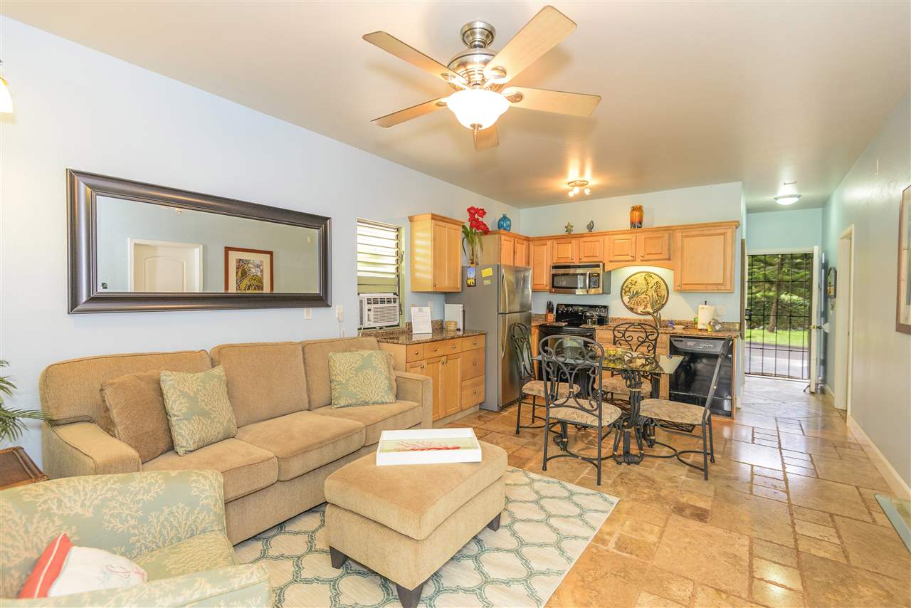 a living room with furniture and kitchen view