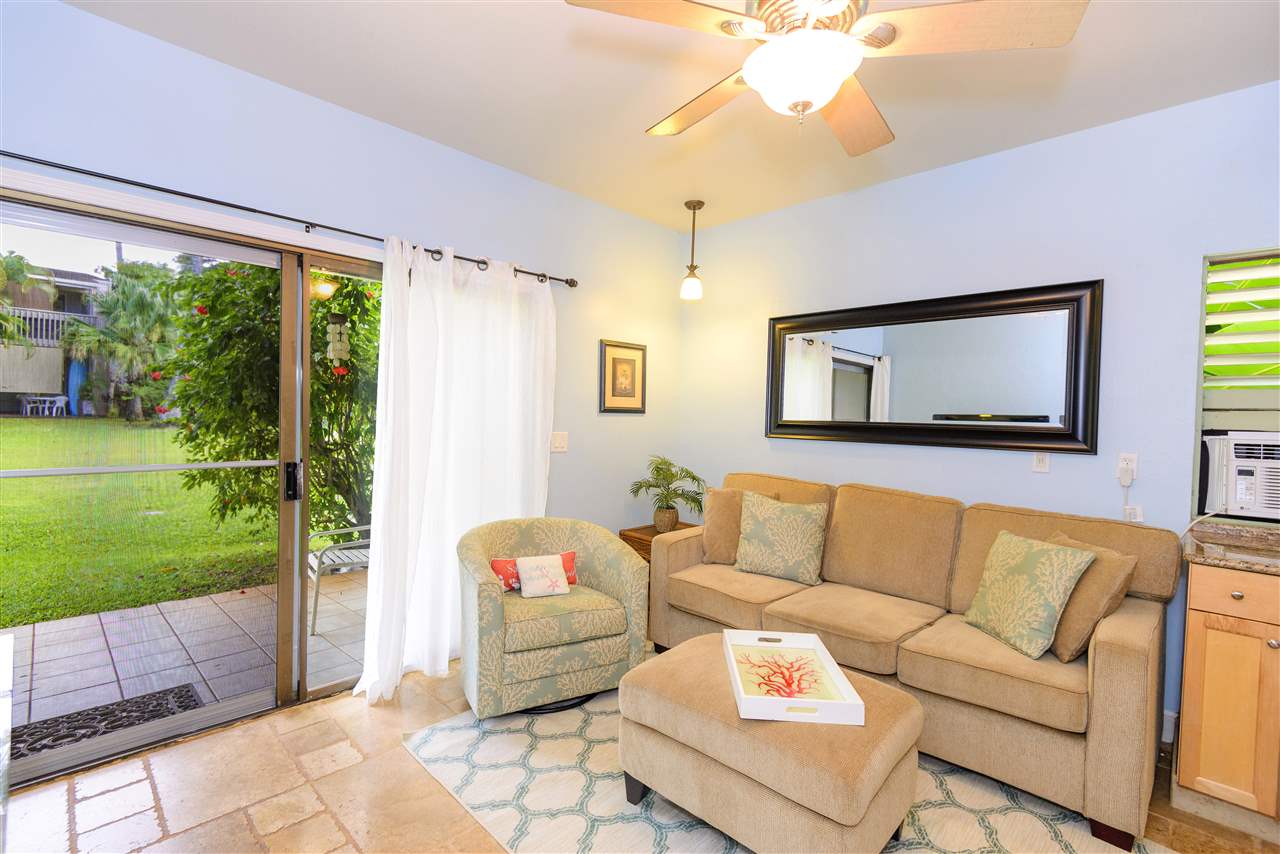 4435 Lower Honoapiilani Road, Unit 115 Lahaina, HI 96761 - Photo 3 of 26 a living room with furniture and a garden