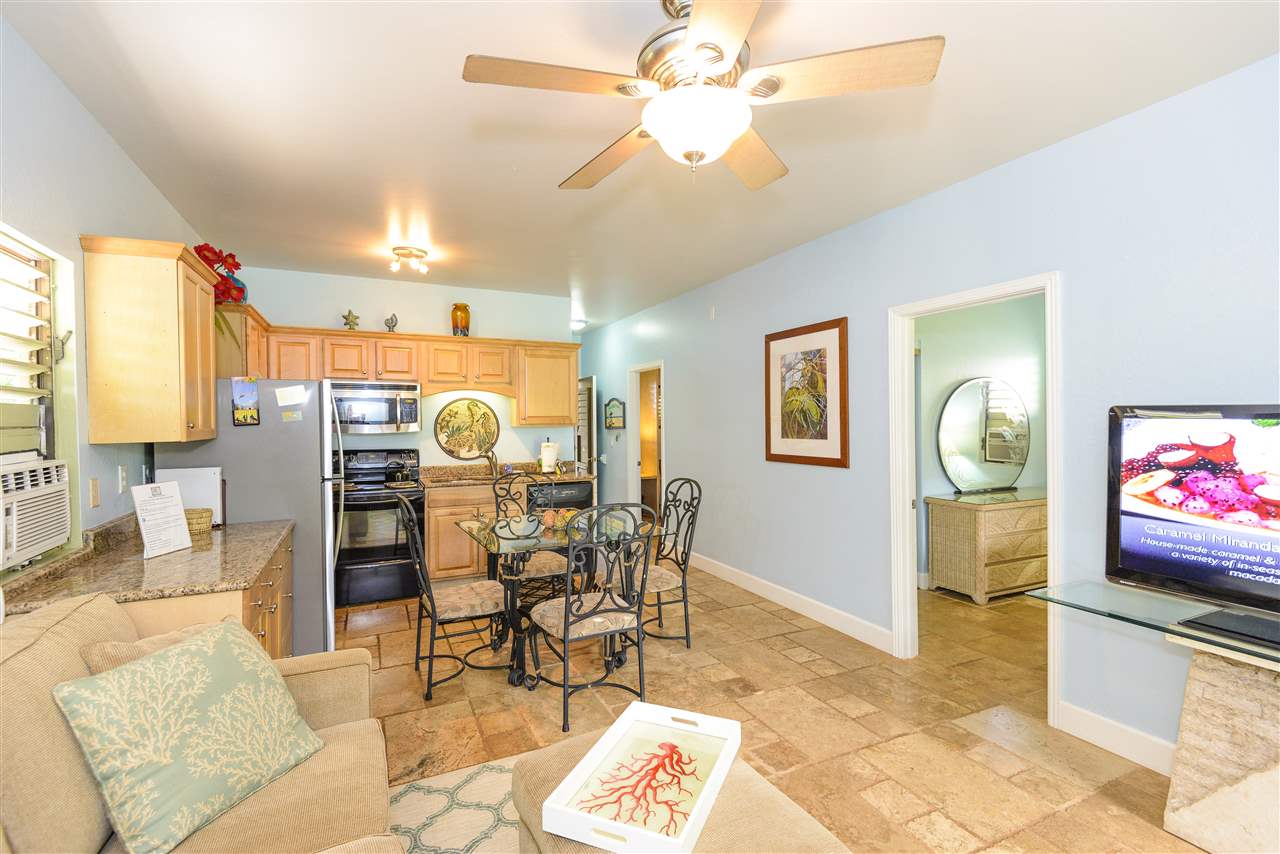 4435 Lower Honoapiilani Road, Unit 115 Lahaina, HI 96761 - Photo 5 of 26 a living room with furniture and a flat screen tv
