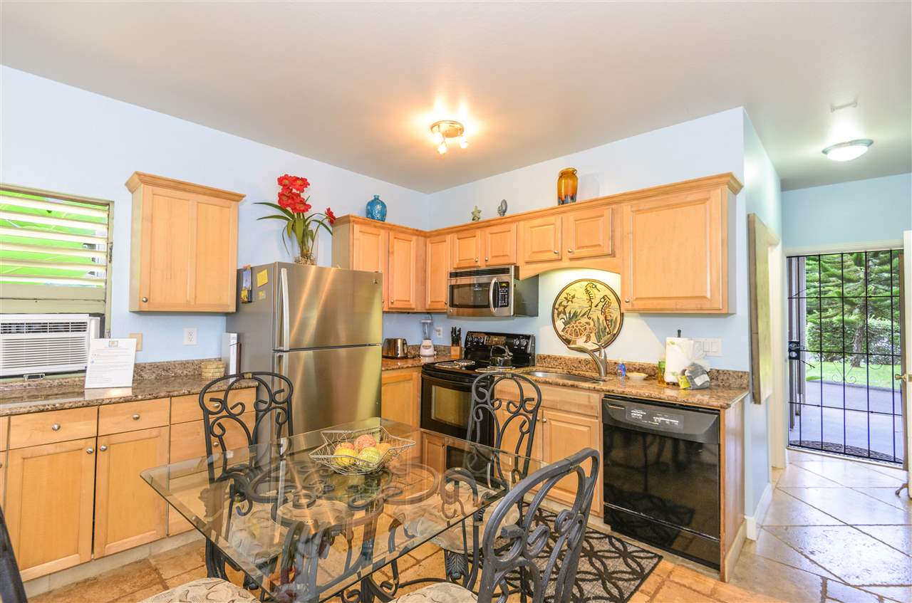 4435 Lower Honoapiilani Road, Unit 115 Lahaina, HI 96761 - Photo 8 of 26 a view of a kitchen with dining table and chairs