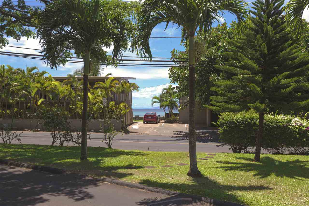 4435 Lower Honoapiilani Road, Unit 115 Lahaina, HI 96761 - Photo 9 of 26 a front view of a house with a yard and trees