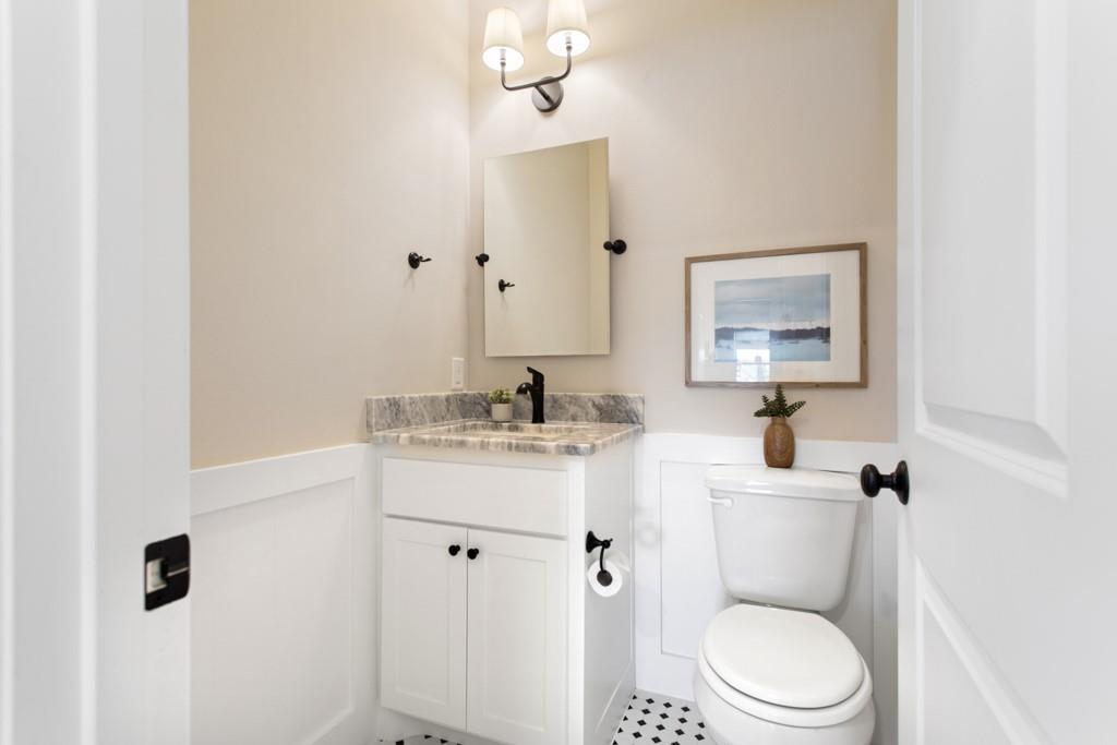 23630 Champion Drive Lindale, TX 75771 - Photo 19 of 36 a bathroom with a toilet a sink and mirror
