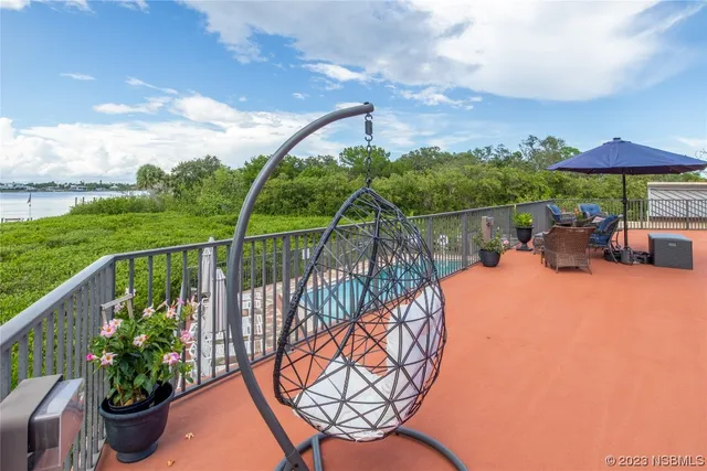 a balcony with furniture and an umbrella